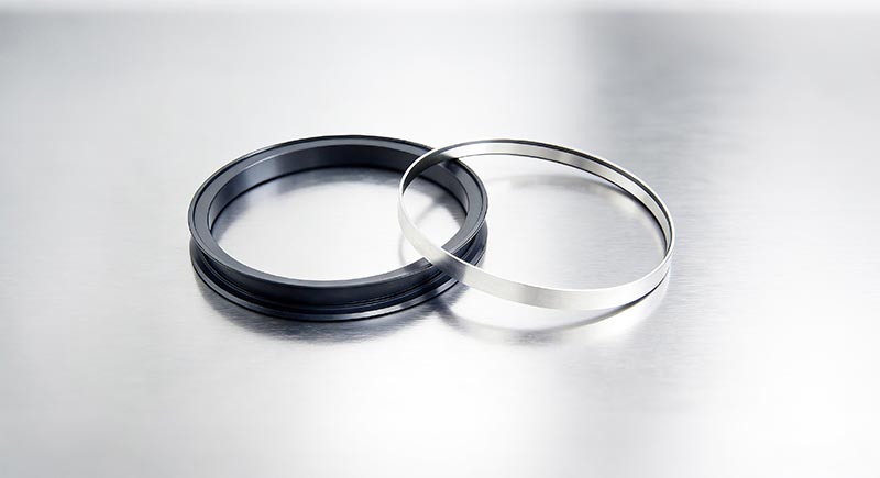 軋機(jī)速度超90米/秒，什么高線軋機(jī)密封件能扛??？ 高溫水汽油混合，密封易壞？選對(duì)高線軋機(jī)密封件？ 頻繁停機(jī)換密封？長(zhǎng)效型高線軋機(jī)密封件是關(guān)鍵? 在高速線材生產(chǎn)線上，軋輥軸承座的活塞桿正以90-100米/秒的驚人速度往復(fù)運(yùn)動(dòng)，這比高鐵速度還要快。在如此極端的高速摩擦下，普通橡膠密封件會(huì)迅速產(chǎn)生高溫，材料軟化磨損，通常數(shù)日內(nèi)即告失效，導(dǎo)致潤(rùn)滑油泄漏、冷卻水侵入。這直接造成軸承潤(rùn)滑不良，溫度飆升，最終引發(fā)昂貴的軸承燒毀事故，每次非計(jì)劃停機(jī)更換都意味著巨大的產(chǎn)量損失。專為這一嚴(yán)苛工況設(shè)計(jì)的高線軋機(jī)密封件，其核心采用了具有極低摩擦系數(shù)的聚四氟乙烯（PTFE）作為密封唇材料，輔以不銹鋼骨架提供強(qiáng)力支撐，從而在超高速度下仍能保持穩(wěn)定的密封性能和超長(zhǎng)使用壽命，是應(yīng)對(duì)高速挑戰(zhàn)的根本解決方案。  高溫蒸汽與冷卻水交織，密封件如何在“冰火兩重天”中不失效？ 高線軋機(jī)軸承座的工作環(huán)境異常復(fù)雜：內(nèi)部是超過110℃的高溫潤(rùn)滑油，外部則充斥著用于冷卻的軋制水和隨之產(chǎn)生的高溫水蒸氣。這種高溫、水汽與潤(rùn)滑油共存的惡劣工況，要求密封件材料必須同時(shí)具備卓越的耐高溫性、抗介質(zhì)性和尺寸穩(wěn)定性。傳統(tǒng)的丁腈橡膠（NBR）在此環(huán)境下極易硬化老化。而高線軋機(jī)密封件所使用的PTFE復(fù)合材料，天生憎水且化學(xué)性質(zhì)極其穩(wěn)定，能夠長(zhǎng)期耐受潤(rùn)滑油、水和蒸汽的混合侵蝕，在高溫下也不會(huì)發(fā)生顯著變形，確保密封界面始終嚴(yán)密，有效隔絕外部水汽侵入內(nèi)部油腔。  頻繁停機(jī)更換密封件，如何保障連續(xù)生產(chǎn)的效率和效益？ 對(duì)于追求連續(xù)化、高效率的現(xiàn)代化軋鋼生產(chǎn)線而言，設(shè)備可靠性就是生命線。軸承座密封的頻繁失效，導(dǎo)致的不僅僅是密封件本身的更換成本，更會(huì)連鎖引發(fā)軸承損壞、計(jì)劃外停機(jī)和寶貴的生產(chǎn)時(shí)間損失。一次計(jì)劃外停機(jī)可能造成每小時(shí)數(shù)萬元的產(chǎn)值損失。因此，選擇一款可靠的高線軋機(jī)密封件，實(shí)質(zhì)上是投資于整個(gè)生產(chǎn)線的穩(wěn)定性和綜合效益。它通過優(yōu)異的耐磨性和抗介質(zhì)能力，將維護(hù)周期從“按天計(jì)算”延長(zhǎng)至“按年計(jì)劃”，大幅提升了設(shè)備的平均無故障運(yùn)行時(shí)間。許多專注于工業(yè)密封領(lǐng)域的廣東密封件廠家，正是通過提供此類高性能定制化產(chǎn)品來幫助客戶實(shí)現(xiàn)降本增效。  國(guó)產(chǎn)高性能密封解決方案，助力中國(guó)制造業(yè)升級(jí)。 面對(duì)高速線材生產(chǎn)線對(duì)密封件越來越苛刻的要求，國(guó)內(nèi)密封行業(yè)正在積極迎戰(zhàn)。本土制造商不僅需要提供高質(zhì)量的產(chǎn)品，更需要對(duì)軋鋼工藝有深入的理解，才能設(shè)計(jì)出真正貼合工況的密封方案。一些技術(shù)領(lǐng)先的廣東密封件廠家已經(jīng)在此領(lǐng)域積累了豐富的經(jīng)驗(yàn)。例如，廣東東晟密封件廠家等企業(yè)，能夠針對(duì)不同軋機(jī)型號(hào)和具體工況，提供從材料配方、結(jié)構(gòu)設(shè)計(jì)到安裝指導(dǎo)的全套解決方案。國(guó)產(chǎn)高性能高線軋機(jī)密封件的成熟與應(yīng)用，正在逐步打破國(guó)外品牌在此領(lǐng)域的壟斷，以可靠的性能和更優(yōu)的性價(jià)比，為中國(guó)制造業(yè)的裝備升級(jí)與成本控制提供有力支撐。  一、性能測(cè)試標(biāo)準(zhǔn) GB/T 32217-2015《#液壓傳動(dòng)密封裝置評(píng)定液壓往復(fù)運(yùn)動(dòng)密封件性能的試驗(yàn)方法》 現(xiàn)行國(guó)家標(biāo)準(zhǔn)，專門用于評(píng)定往復(fù)運(yùn)動(dòng)密封件的性能。 為您文章中所有關(guān)于密封性能、可靠性的論述提供了國(guó)家標(biāo)準(zhǔn)級(jí)的、可驗(yàn)證的測(cè)試方法依據(jù)。   二、行業(yè)應(yīng)用與改造案例 《#高線軋機(jī)初中軋軸承座密封系統(tǒng)改造》（《#潤(rùn)滑與密封》） 行業(yè)核心期刊文章，分析了與您文中描述完全一致的實(shí)際工況問題。